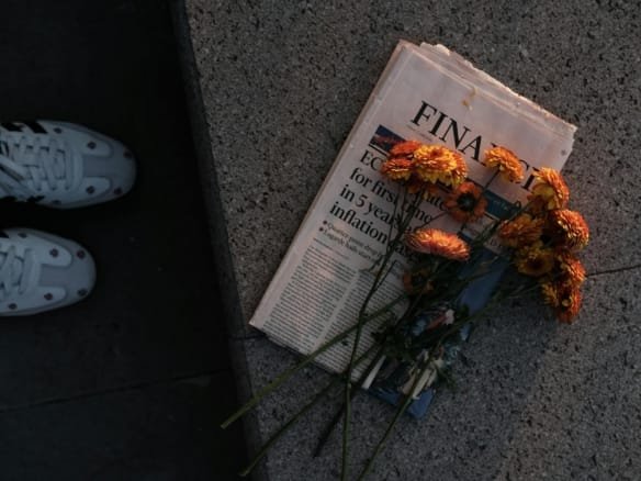 bouquet of flowers on newspaper at sunset