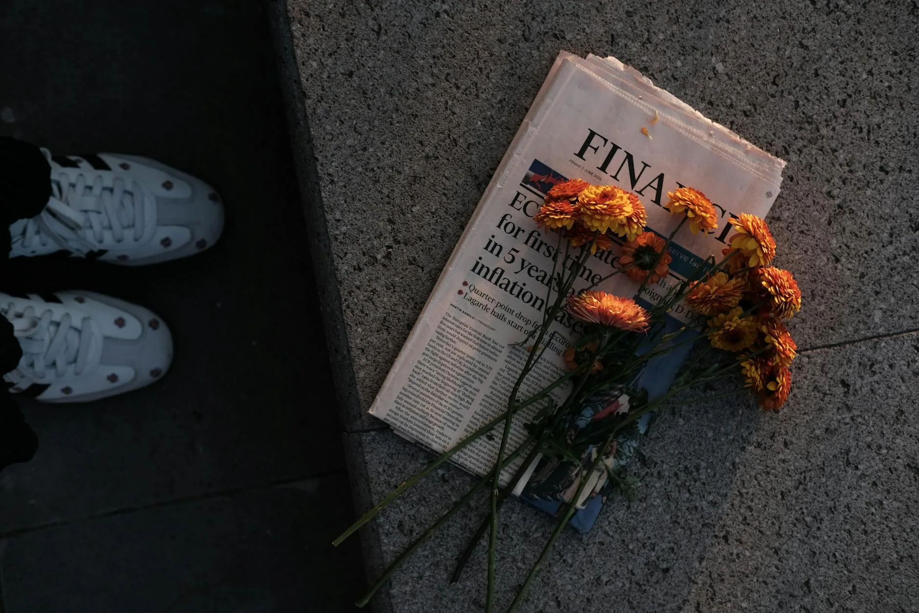 bouquet of flowers on newspaper at sunset